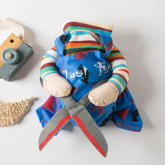 Pet wearing a Chucky doll-inspired Halloween costume with striped shirt and blue overalls