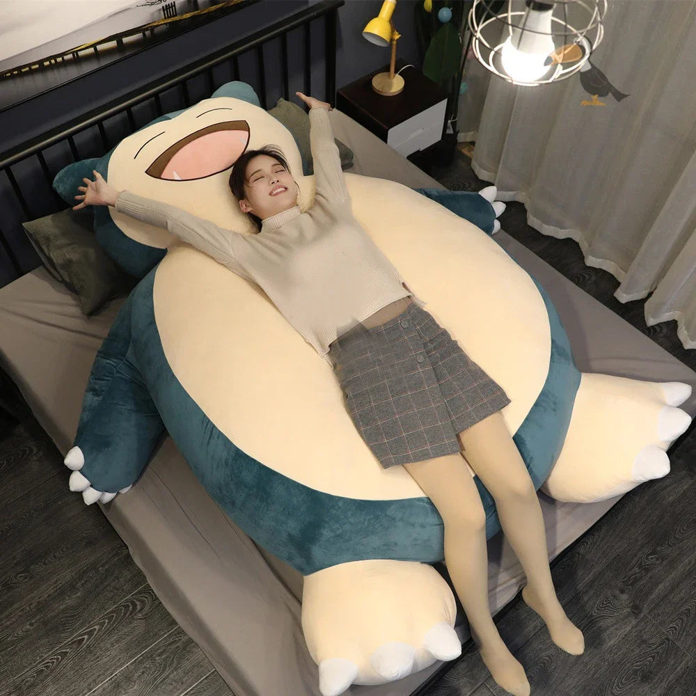 Oversized Snorlax plush lounge cushion used as a floor pillow